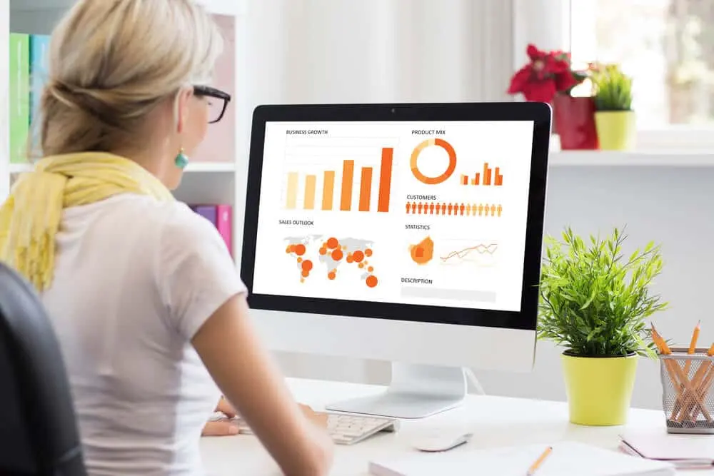 woman looking at CRM data on computer