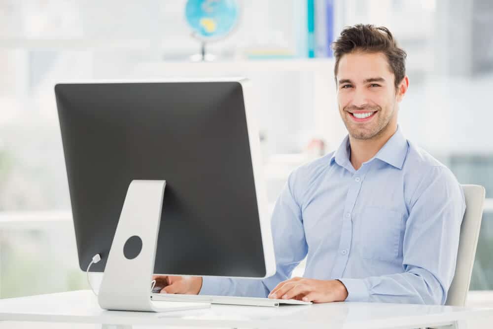 man sitting at computer
