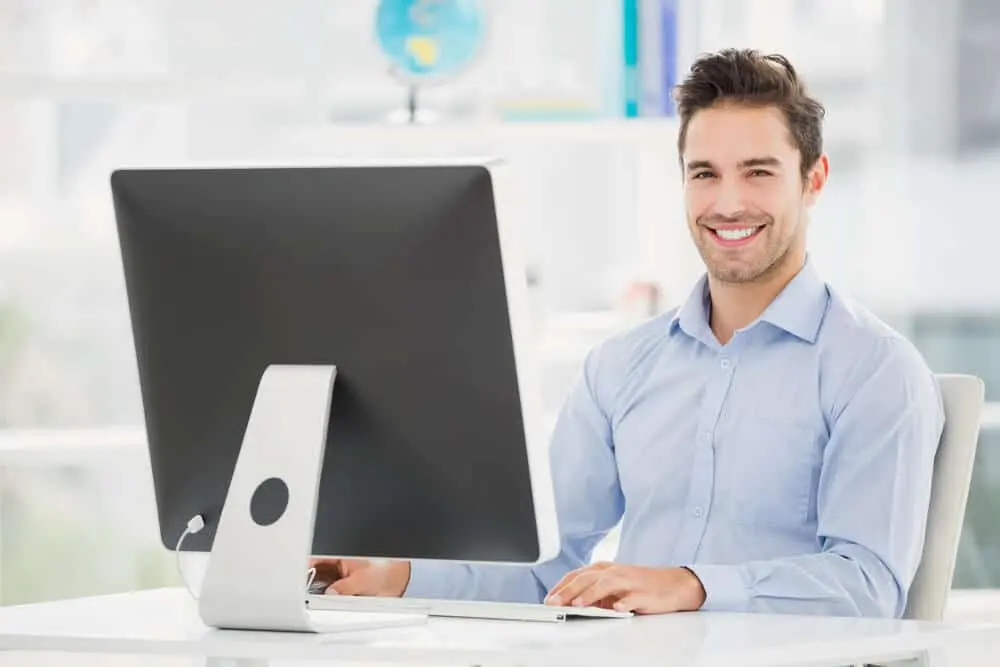 man sitting at computer
