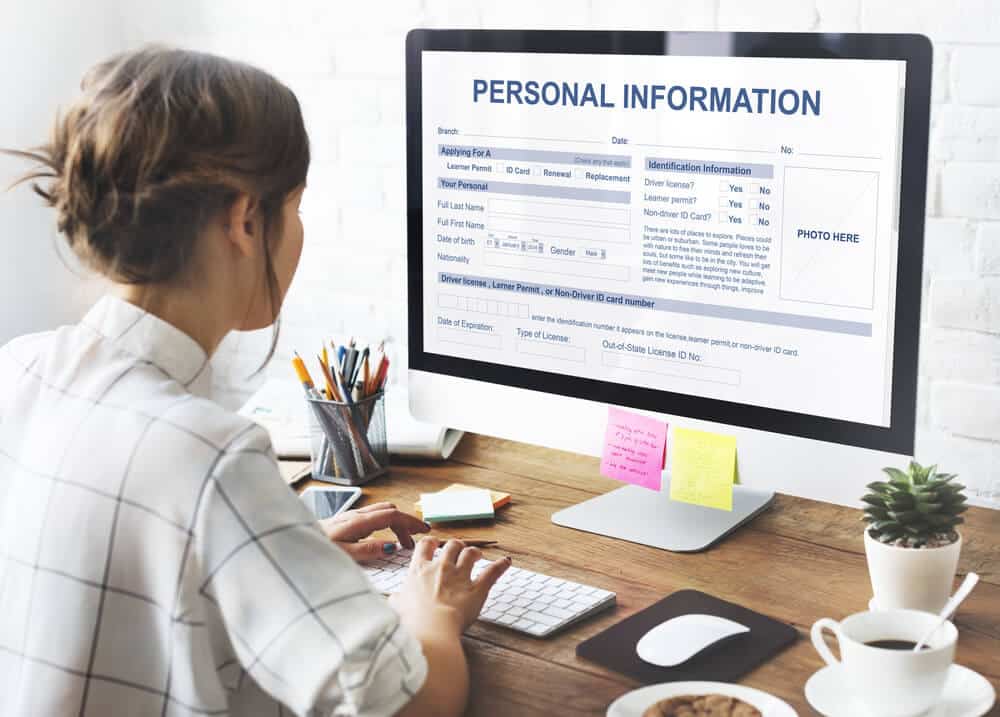 Woman filling out personal information in a computer