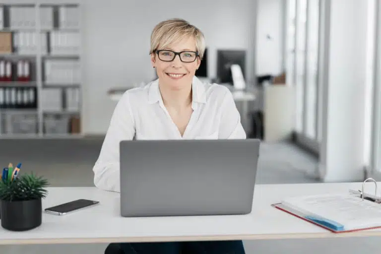 Woman smiling while working on a computer